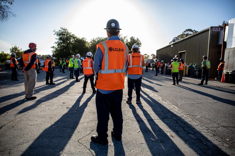 Crews hold an early morning tailgate meeting.