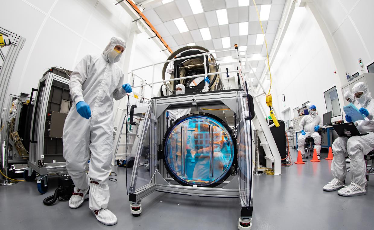 LSST team unpacking an optical filter that will be part of the completed LSST Camera.